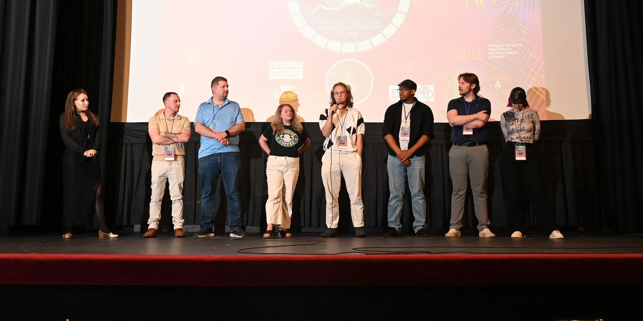 The LIIFE screening panel standing together in front of the theater screen