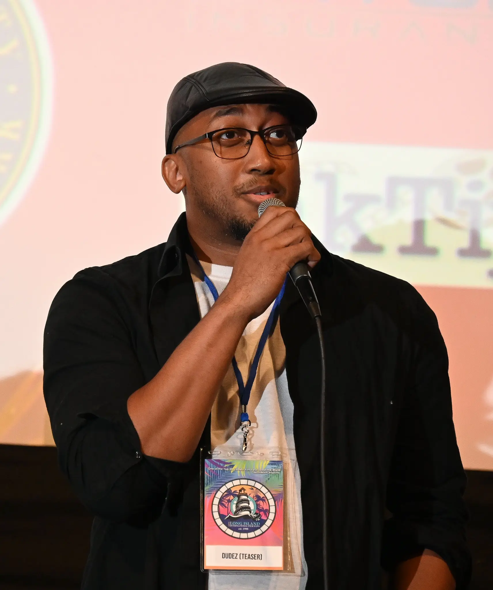 DudeZ filmmaker speaking into a microphone at LIIFE